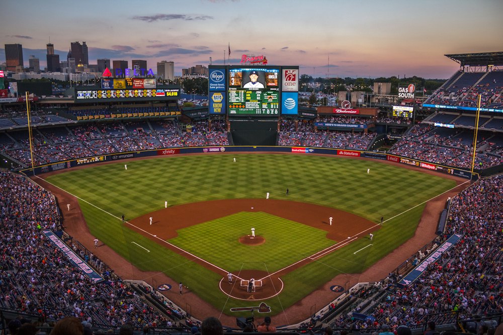 Ballpark full of fans with the city skyline behind