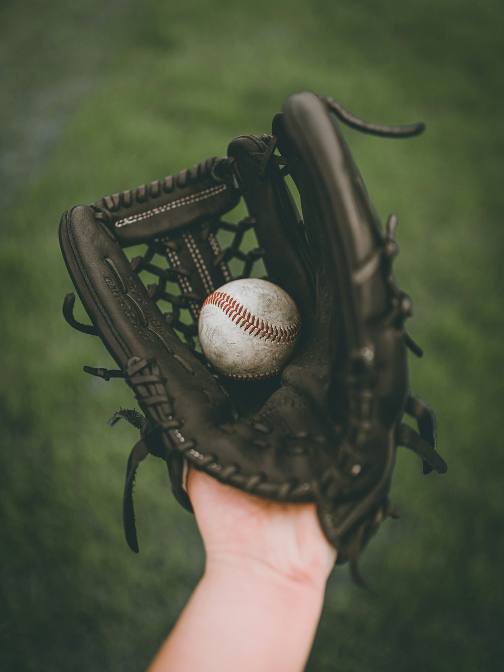 Softball caught in a leather glove