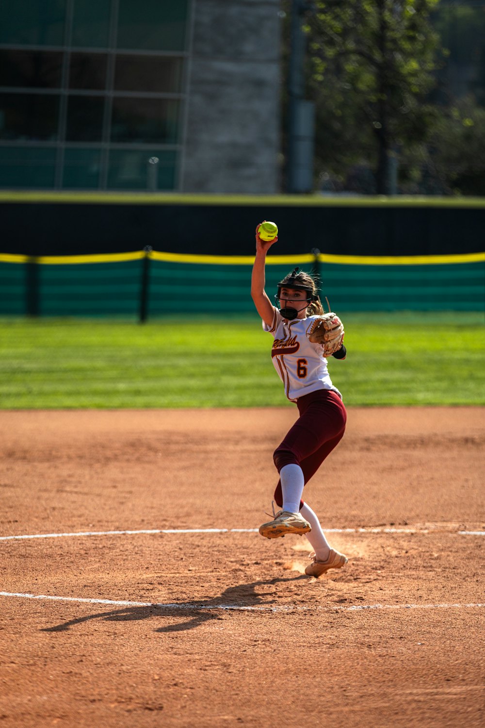 Softball pitcher delivering a pitch