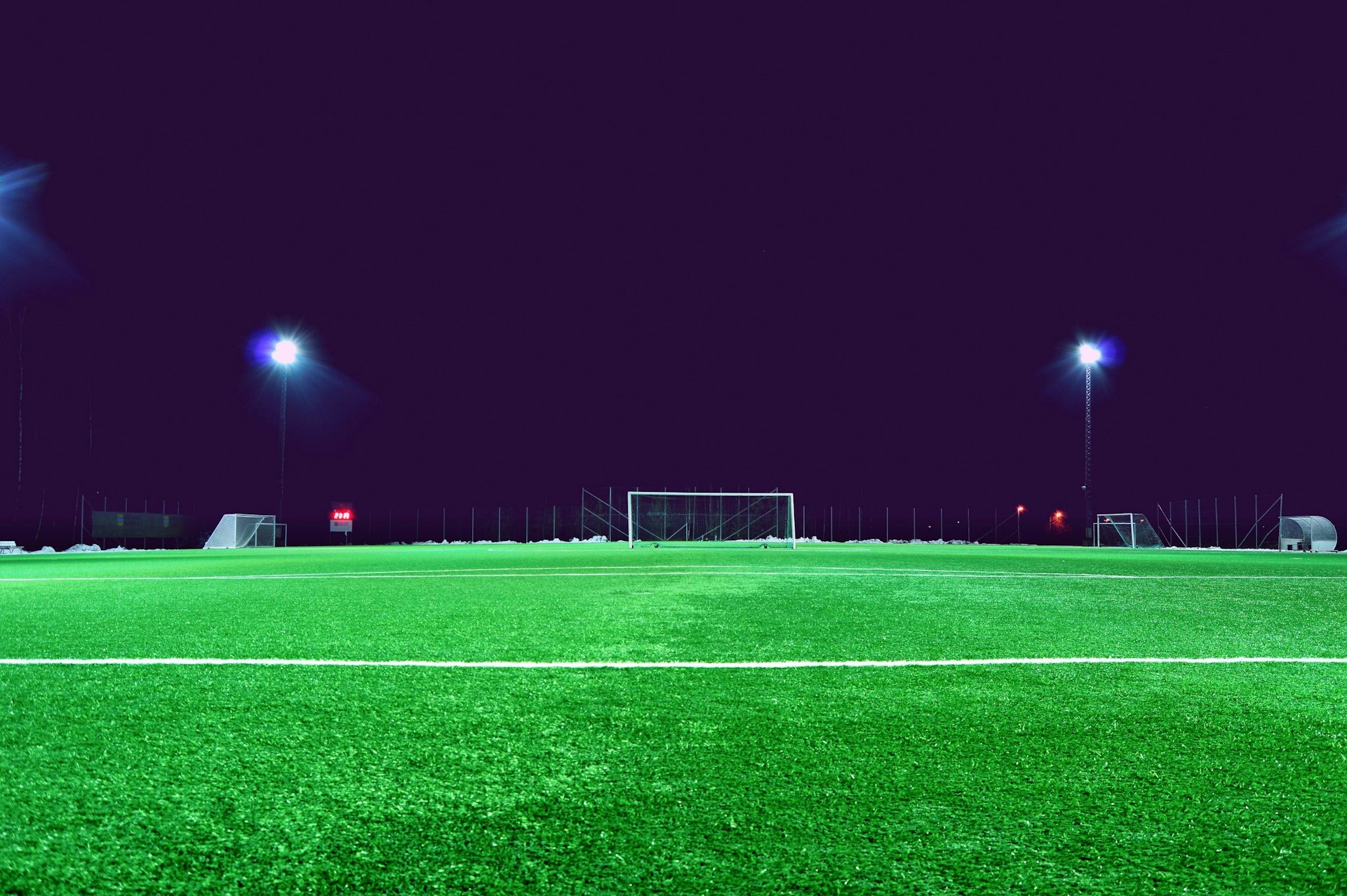 Soccer field under stadium lights at night